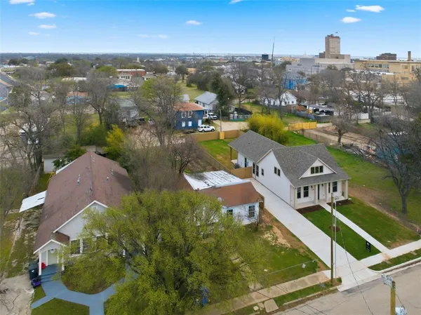 an aerial view of residential houses with outdoor space and river