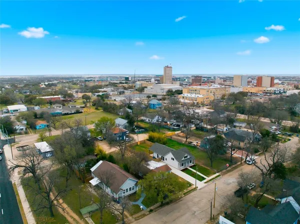 an aerial view of residential houses with city view
