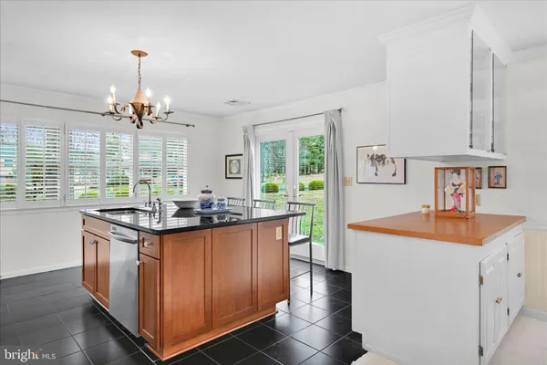 a kitchen with stainless steel appliances granite countertop a sink and a stove