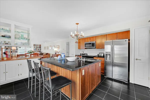 a kitchen with stainless steel appliances a sink counter space cabinets and a window