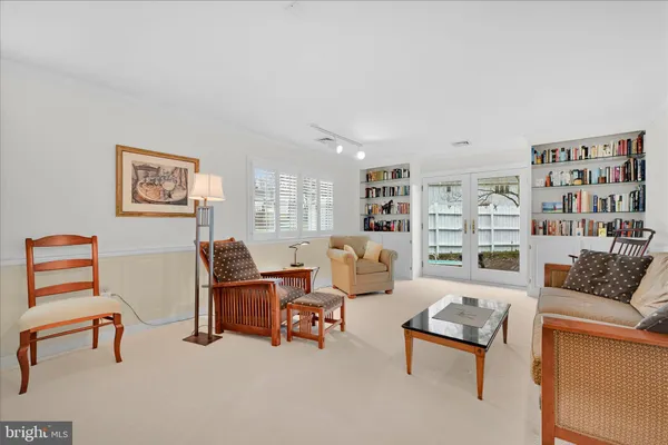 a living room with furniture and a book shelf
