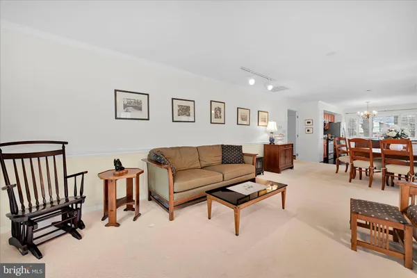 a living room with furniture and a dining table with projector the view