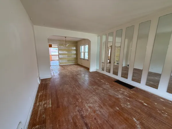 a view of a big room with windows and stairs