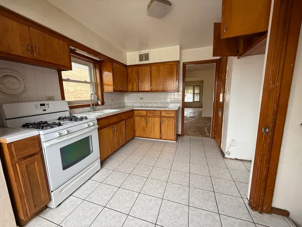 a kitchen with stainless steel appliances a stove a sink and a refrigerator