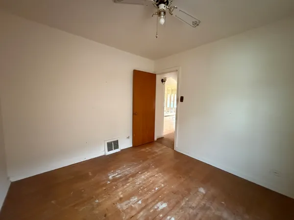 a view of a big room with a chandelier fan