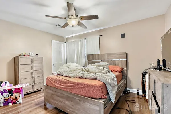a bathroom with a granite countertop sink a toilet and shower