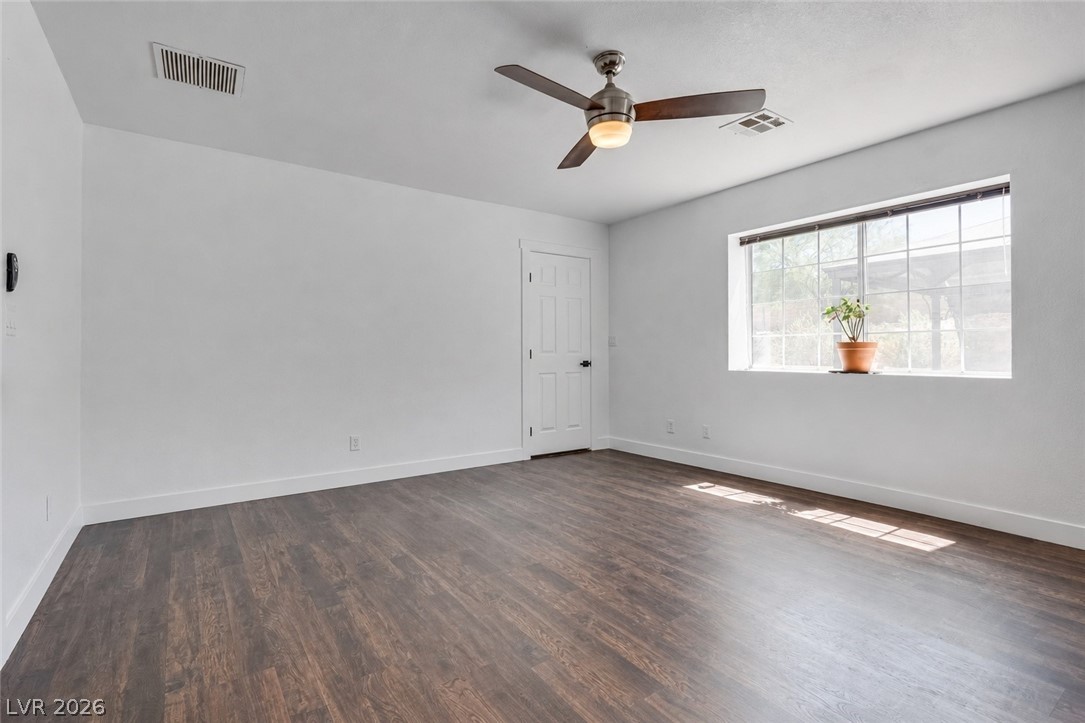 524 Swallow Cove Boulder City, NV 89005 - Photo 19 of 58 Rich wood flooring grounds this airy room, highlighted by a large window and overhead fan.