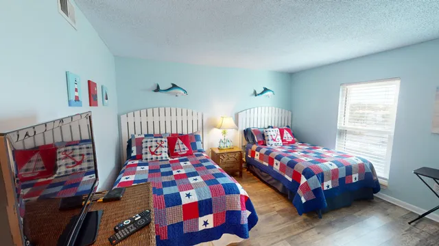 a bedroom with two beds and a window