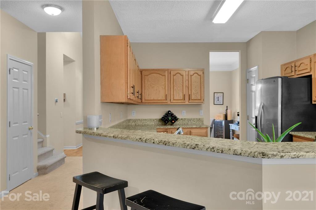 6925 Reedy Creek Road Charlotte, NC 28215 - Photo 14 of 34 a bathroom with a granite countertop sink and a mirror