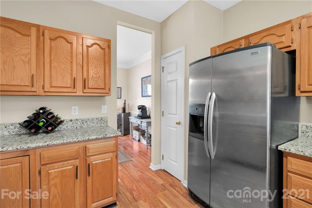 6925 Reedy Creek Road Charlotte, NC 28215 - Photo 16 of 34 a kitchen with stainless steel appliances granite countertop a refrigerator and a sink