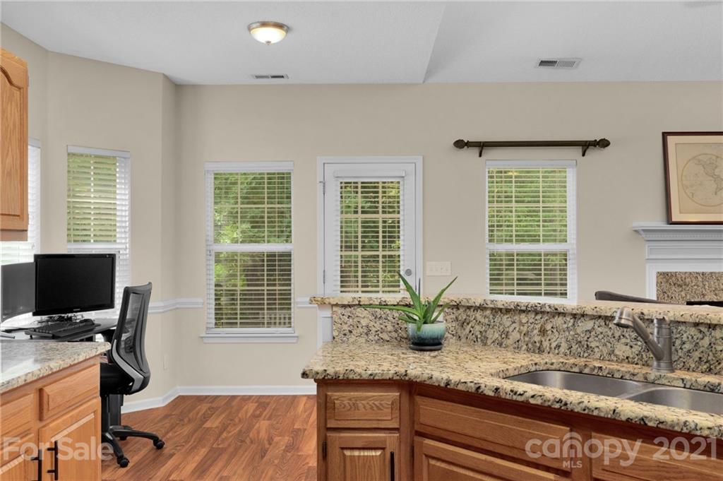 6925 Reedy Creek Road Charlotte, NC 28215 - Photo 17 of 34 a view of a kitchen with granite countertop a sink and a window