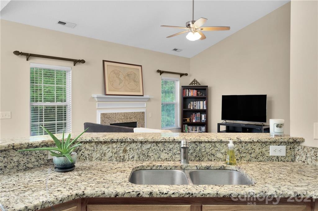 6925 Reedy Creek Road Charlotte, NC 28215 - Photo 18 of 34 a kitchen with granite countertop a sink and a counter top space