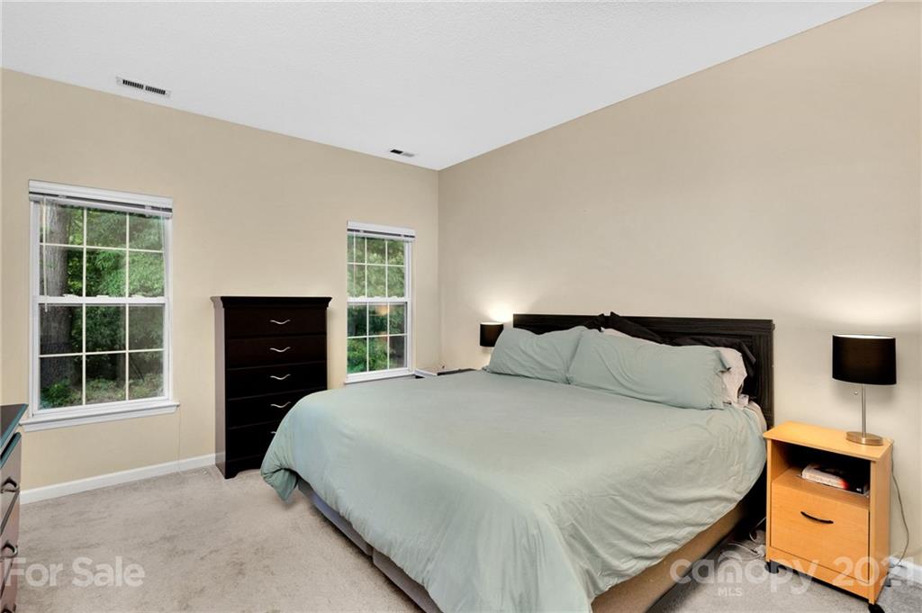 6925 Reedy Creek Road Charlotte, NC 28215 - Photo 19 of 34 a bedroom with a bed and wooden floor