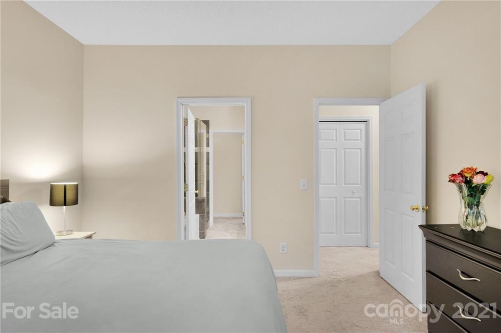 6925 Reedy Creek Road Charlotte, NC 28215 - Photo 20 of 34 a bedroom with a bed and mirror