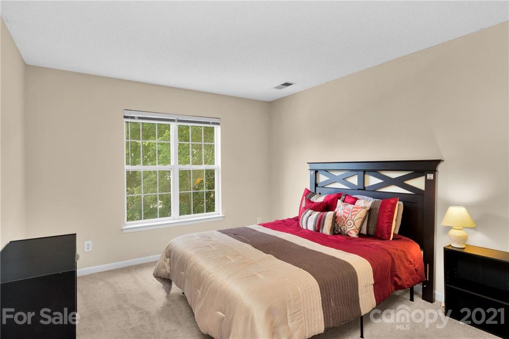 6925 Reedy Creek Road Charlotte, NC 28215 - Photo 23 of 34 a bedroom with a bed and a tv