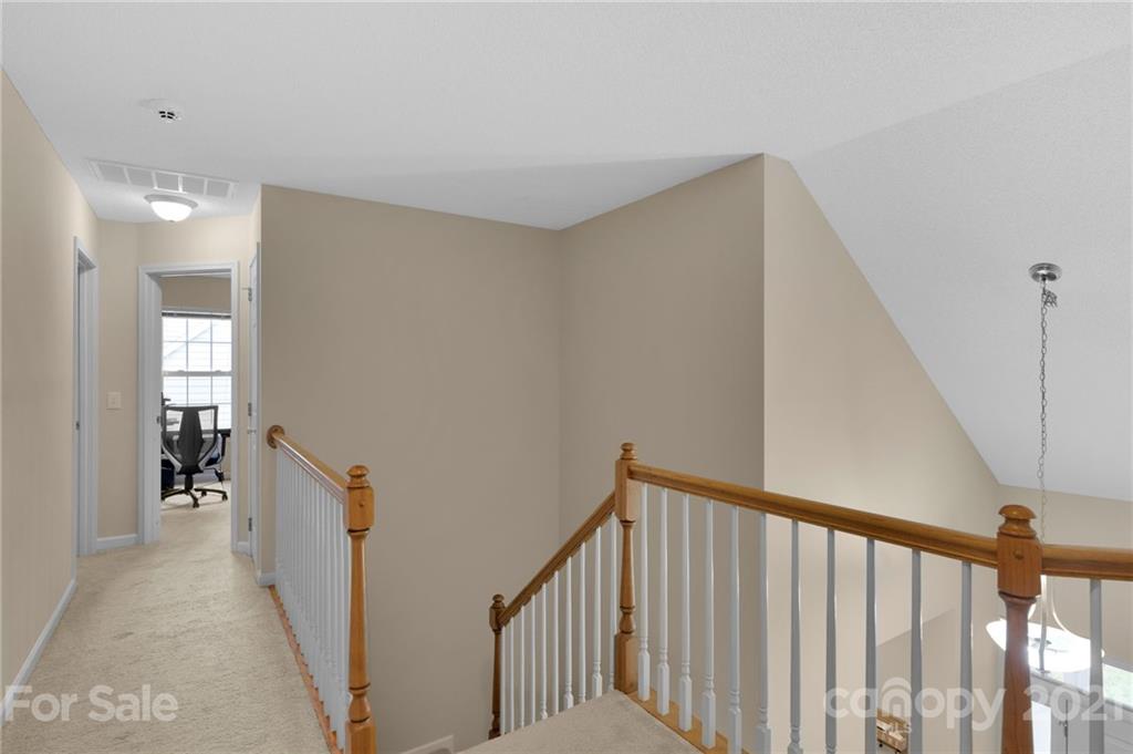 6925 Reedy Creek Road Charlotte, NC 28215 - Photo 28 of 34 a view of a hallway with wooden floor and stairs