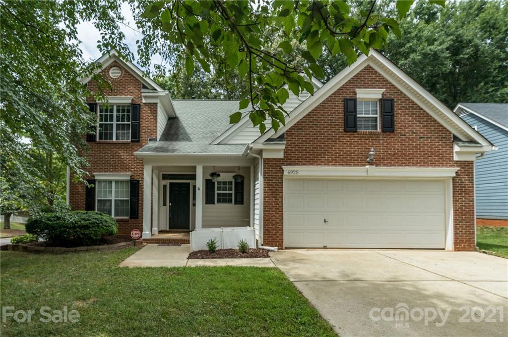 6925 Reedy Creek Road Charlotte, NC 28215 - Photo 34 of 34 a front view of a house with a yard and garage