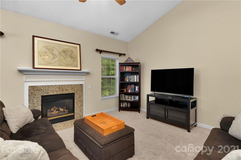 6925 Reedy Creek Road Charlotte, NC 28215 - Photo 8 of 34 a living room with furniture and a flat screen tv