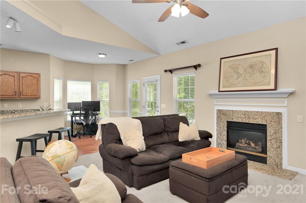 6925 Reedy Creek Road Charlotte, NC 28215 - Photo 9 of 34 a living room with furniture fireplace and window