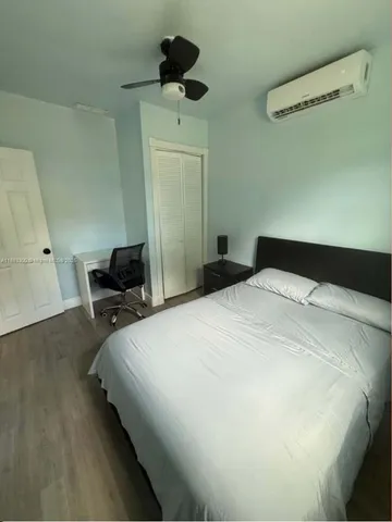 a bedroom with a bed and a ceiling fan