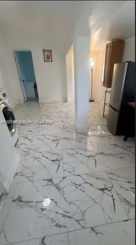 a view of a hallway with seating area