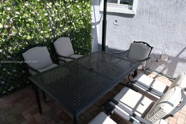 a backyard of a house with table and chairs