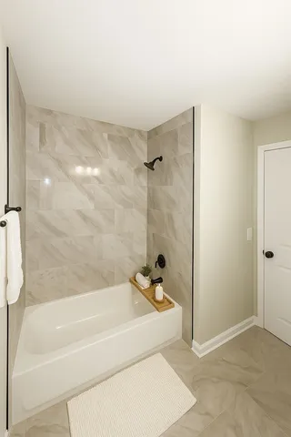 a bathroom with a bathtub and a shower