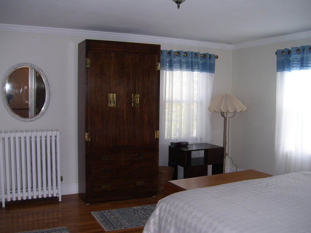 4 Roberts Road Wellesley, MA 02481 - Photo 27 of 29 a bedroom with a bed and a chandelier
