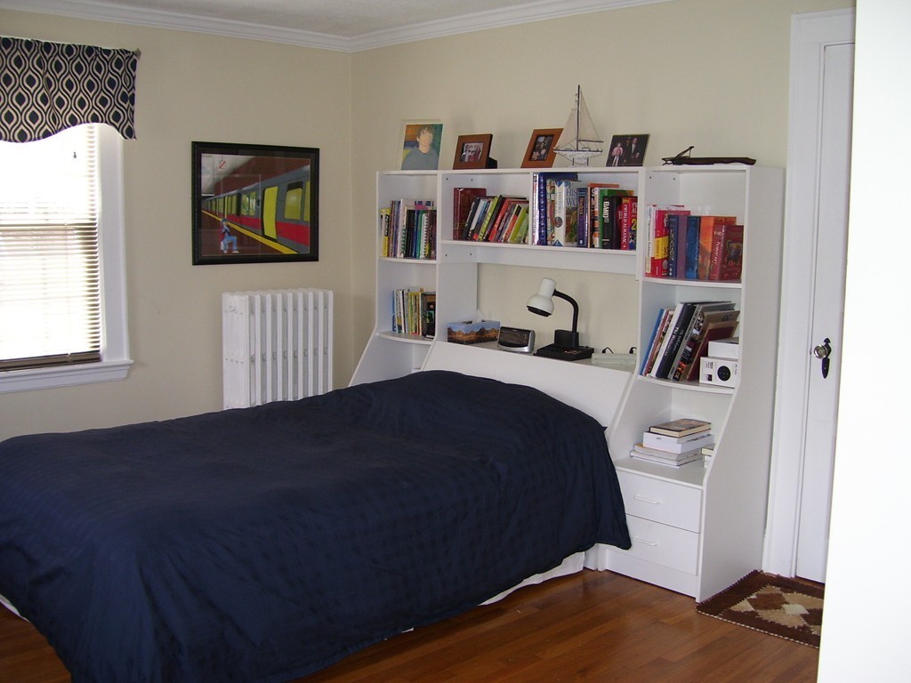 4 Roberts Road Wellesley, MA 02481 - Photo 29 of 29 a bedroom with a bed and a book shelf