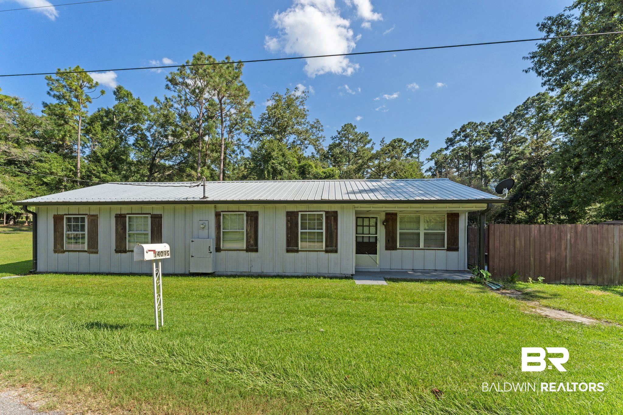 14095 Riverside Drive Foley, AL 36535 - Photo 1 of 30 Single story home featuring board and batten siding, a metal roof, and covered porch
