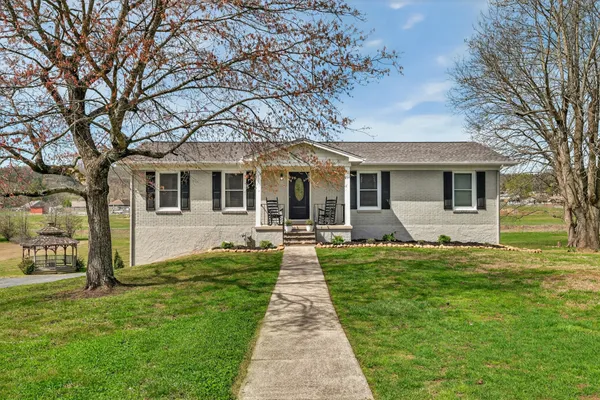 a front view of a house with yard patio and green space