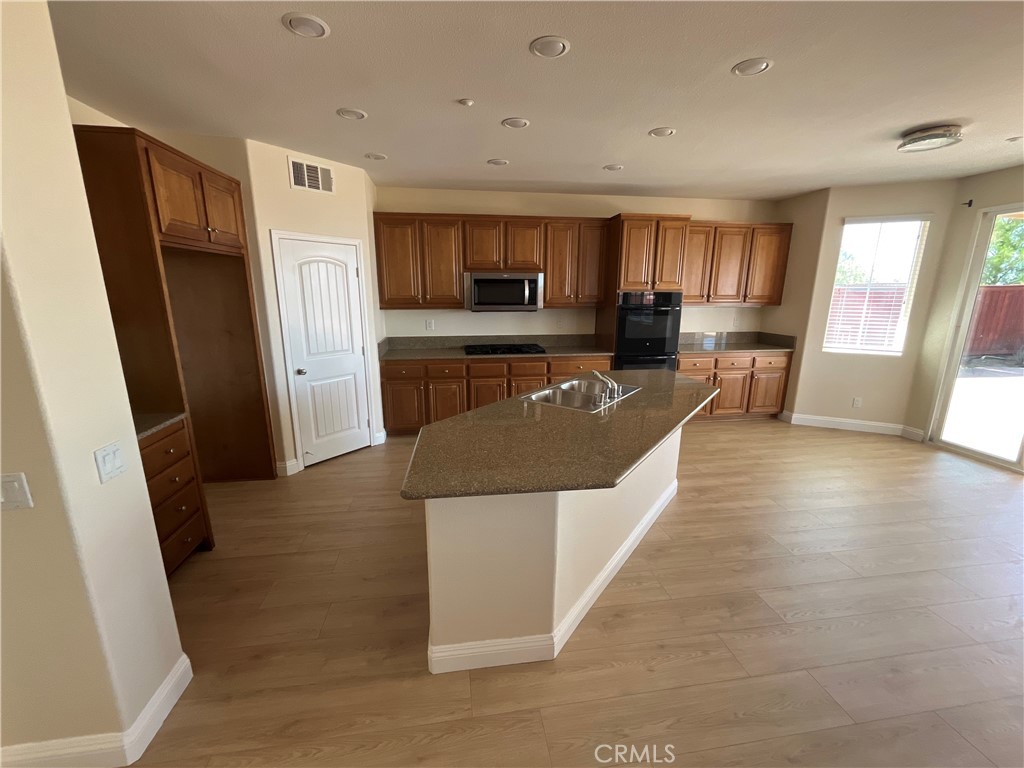 18388 Hidden Ranch Road Riverside, CA 92508 - Photo 11 of 46 a living room with stainless steel appliances furniture a refrigerator a kitchen a sink a stove a microwave and cabinets