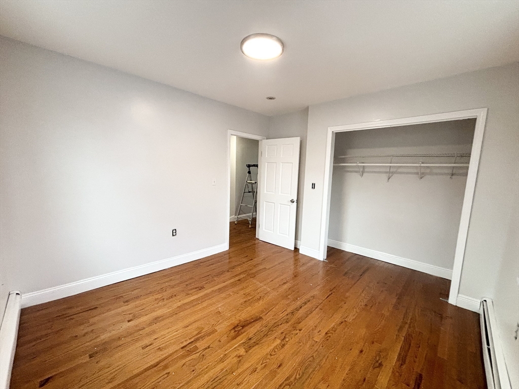 35 Madison Street Malden, MA 02148 - Photo 14 of 16 an empty room with wooden floor and closet