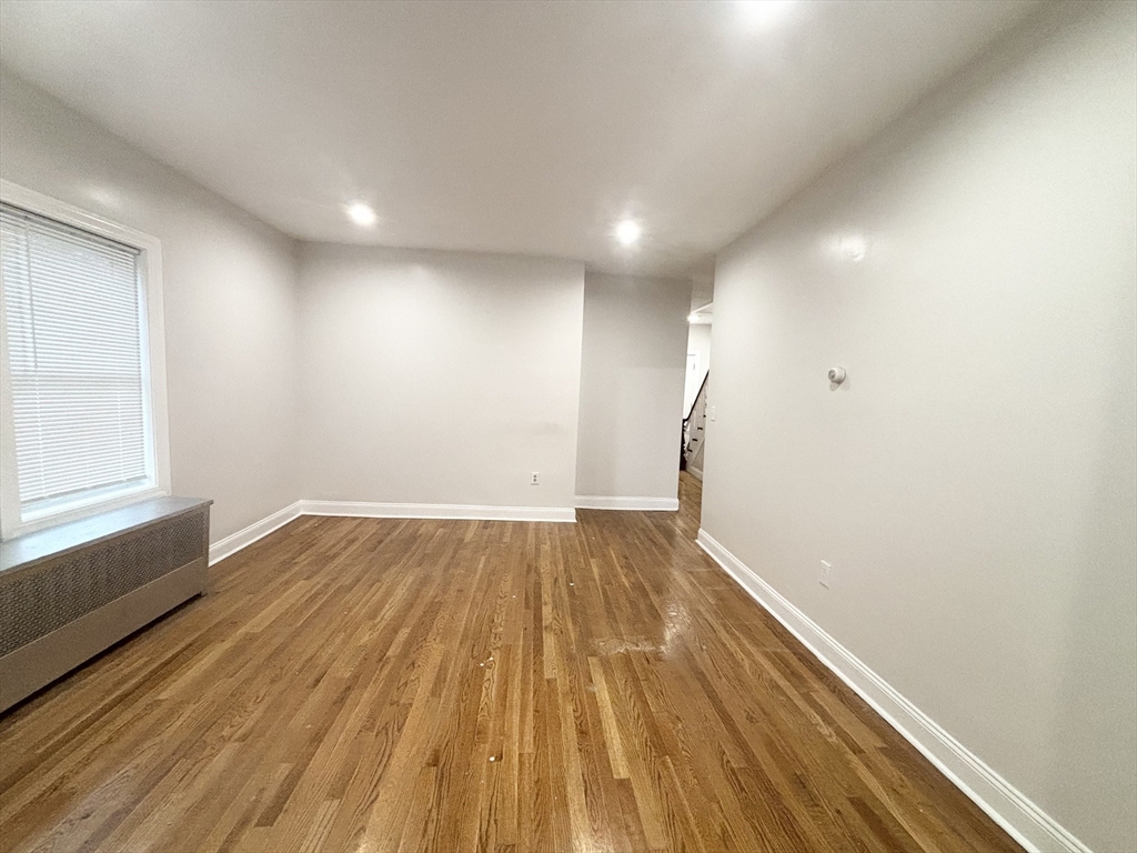 35 Madison Street Malden, MA 02148 - Photo 5 of 16 a view of empty room with wooden floor and fan