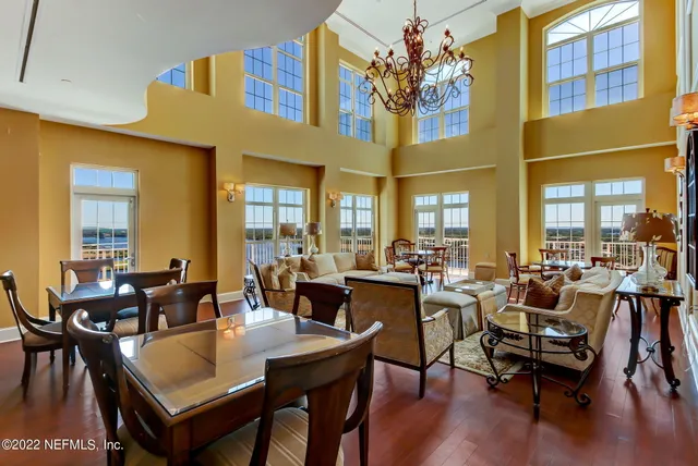 a table and chairs sitting in a roof next to a larger window