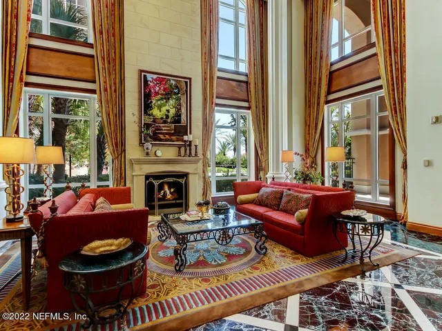 a living room with furniture and a lamp