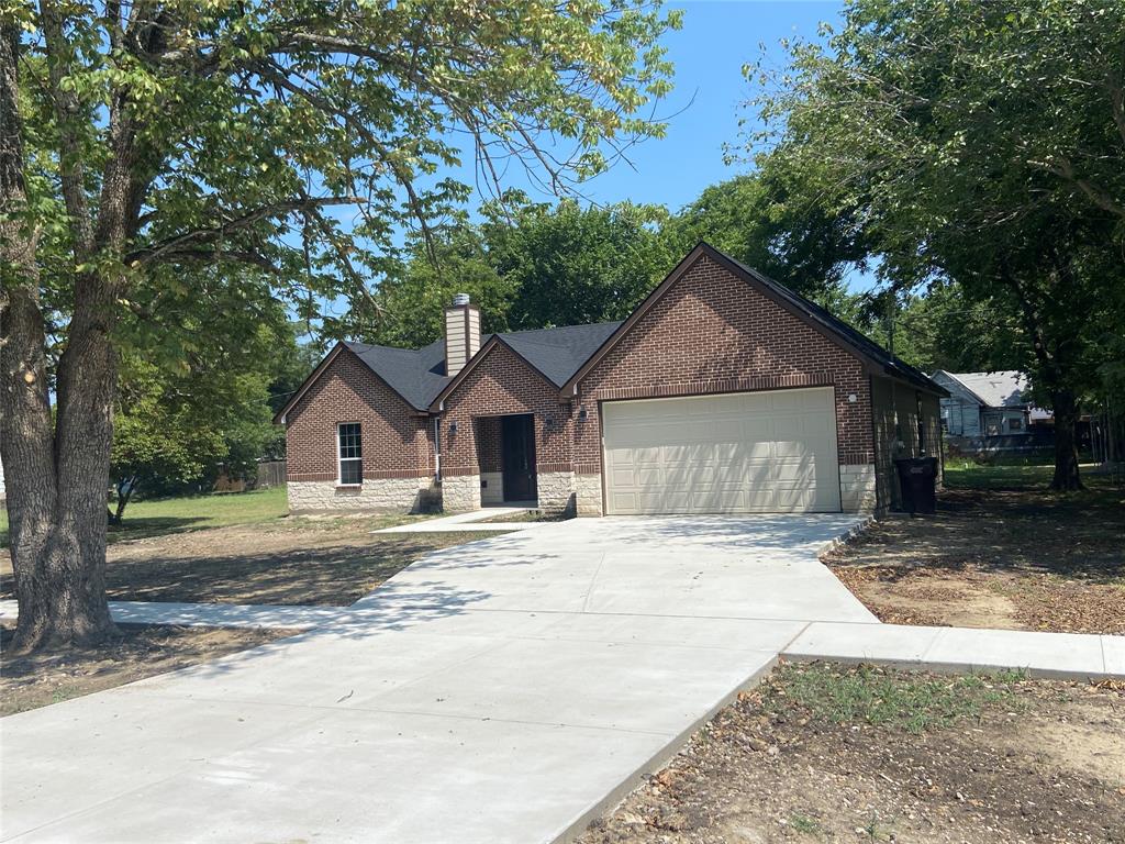206 East Grayson Leonard, TX 75452 - Photo 1 of 1 a front view of a house with a yard and garage