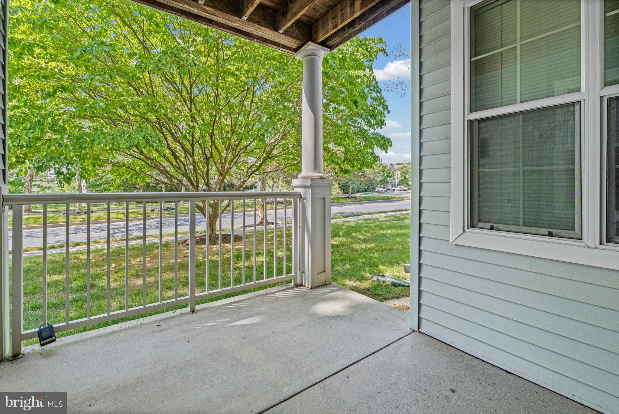 36 Hawk Rise Lane, Unit 104 Owings Mills, MD 21117 - Photo 24 of 25 Serene porch with lush greenery view.