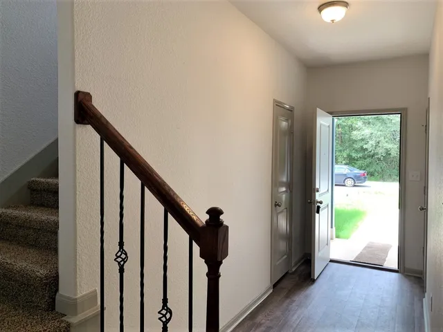 a view of an entryway with wooden floor