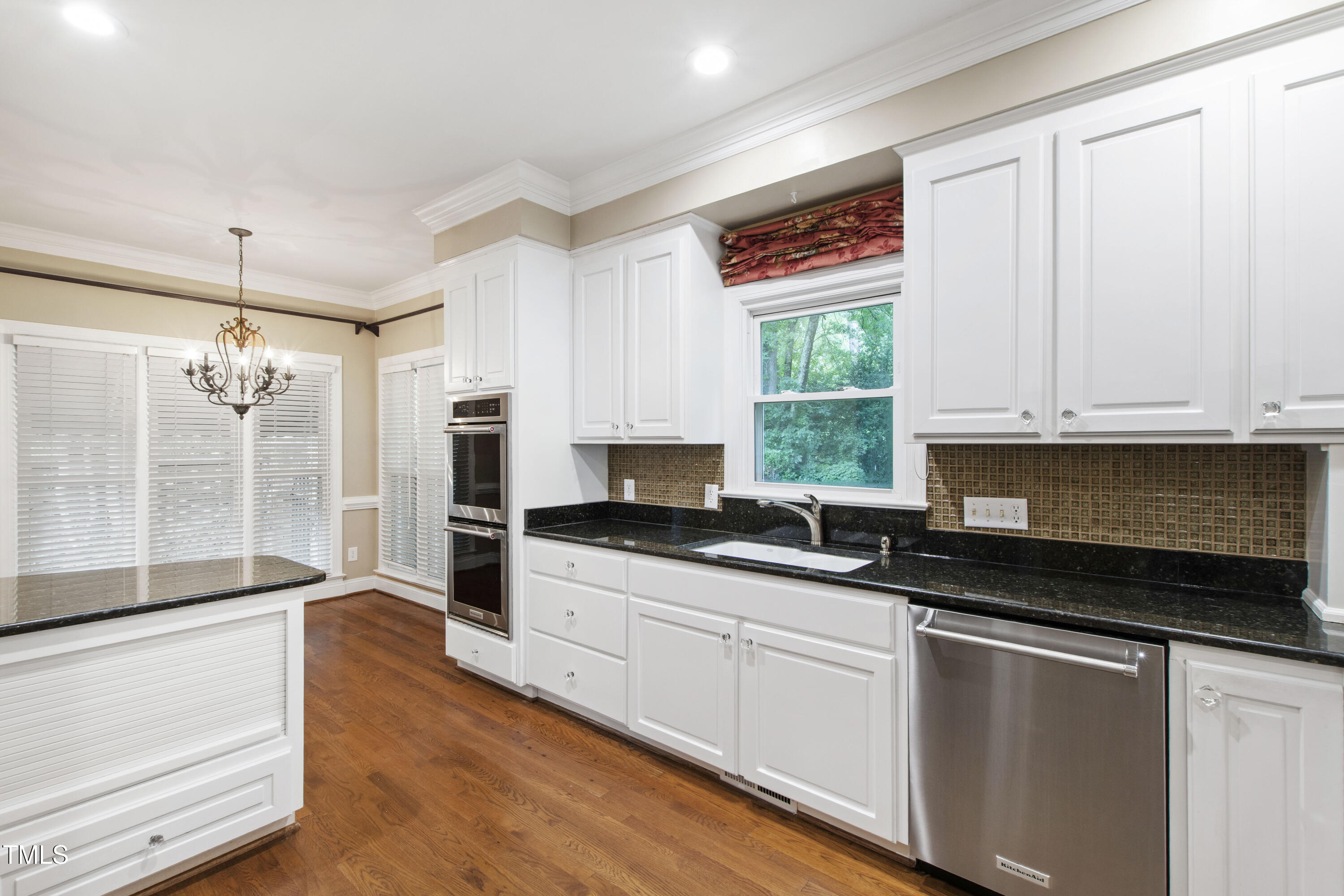 2301 Upper Oaks Way Raleigh, NC 27615 - Photo 16 of 55 a kitchen with granite countertop a stove a sink and a granite counter top space