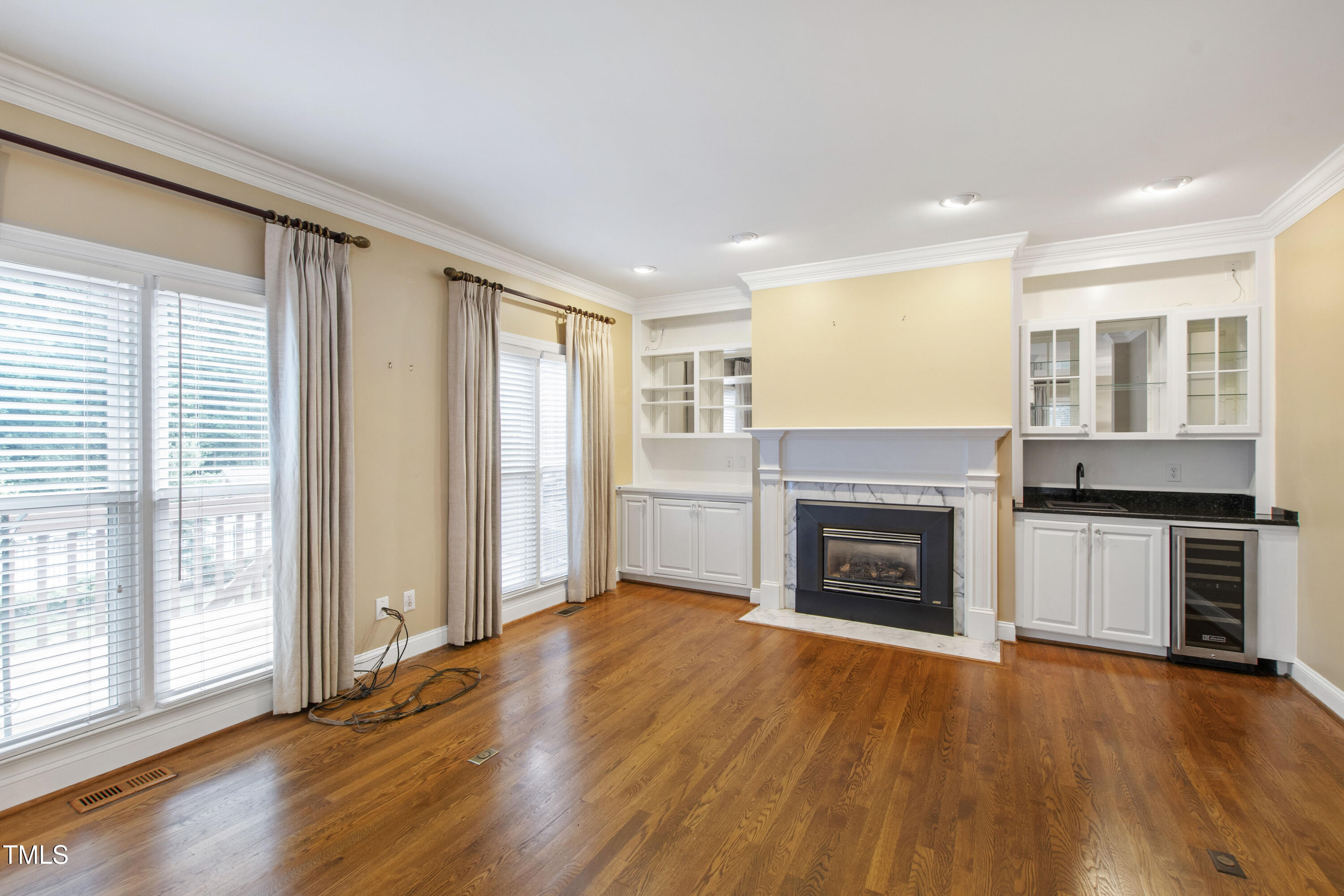 2301 Upper Oaks Way Raleigh, NC 27615 - Photo 24 of 55 a view of an empty room with a fireplace and a window