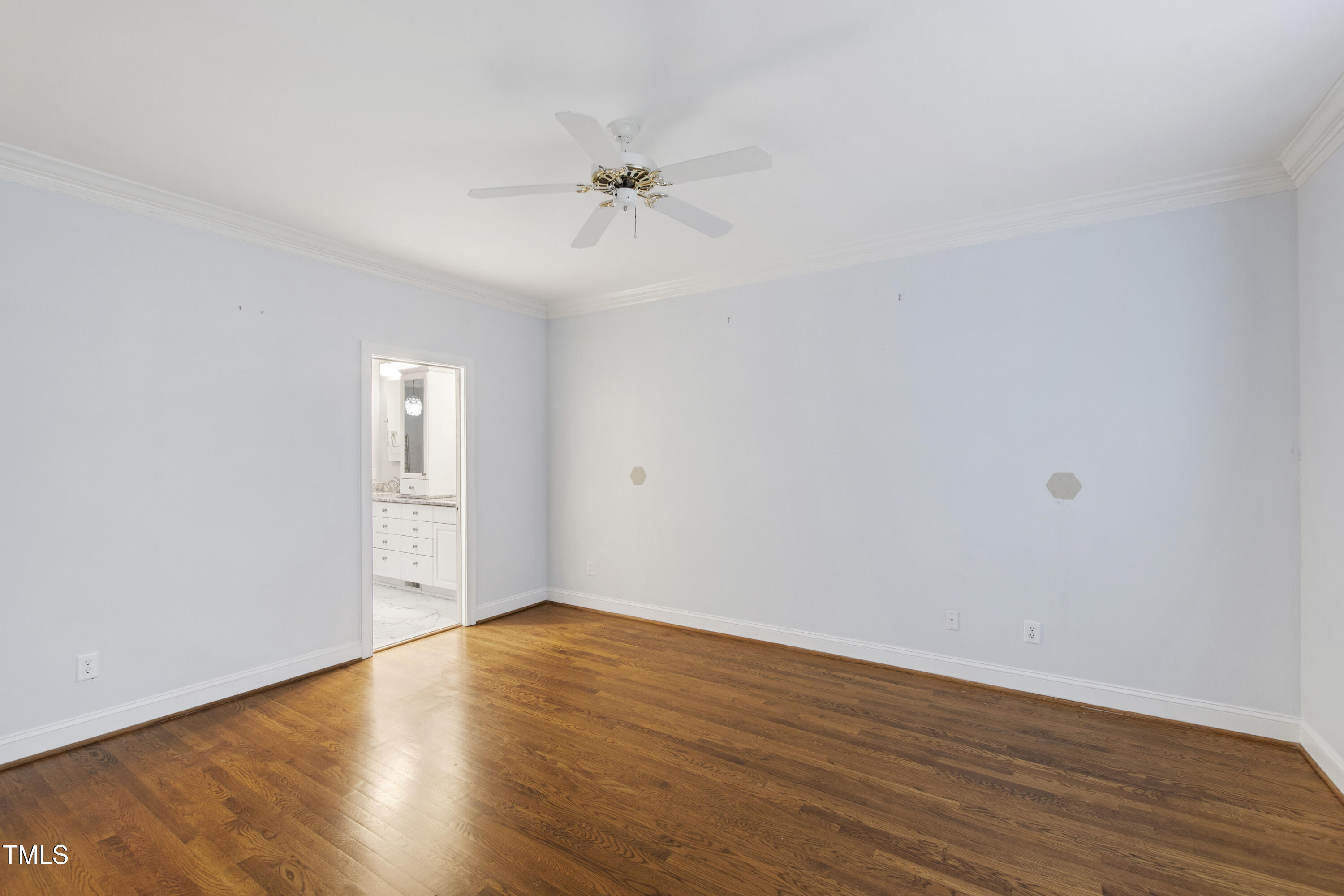 2301 Upper Oaks Way Raleigh, NC 27615 - Photo 27 of 55 a view of an empty room with wooden floor and a ceiling fan