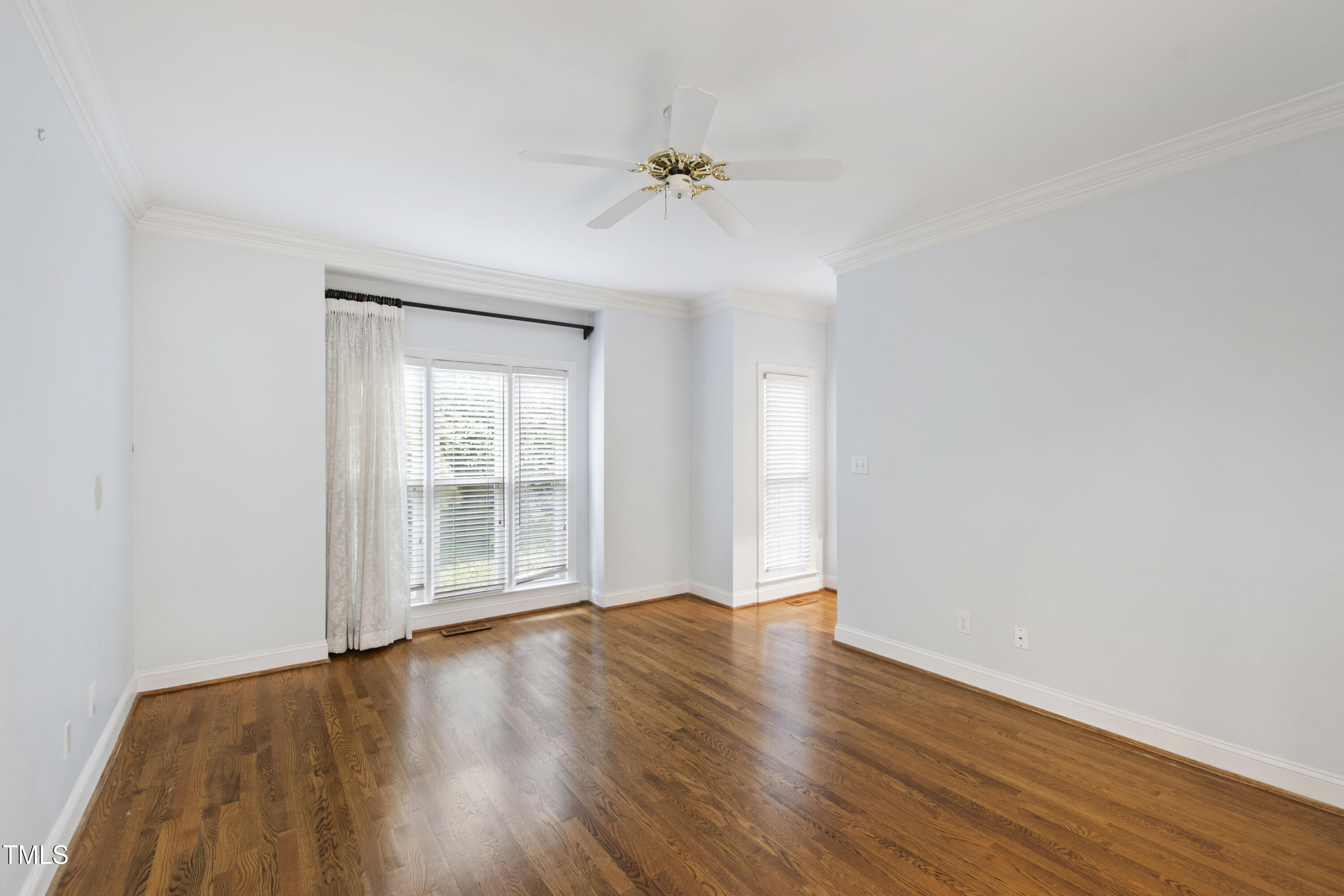2301 Upper Oaks Way Raleigh, NC 27615 - Photo 28 of 55 a view of an empty room with wooden floor and a window