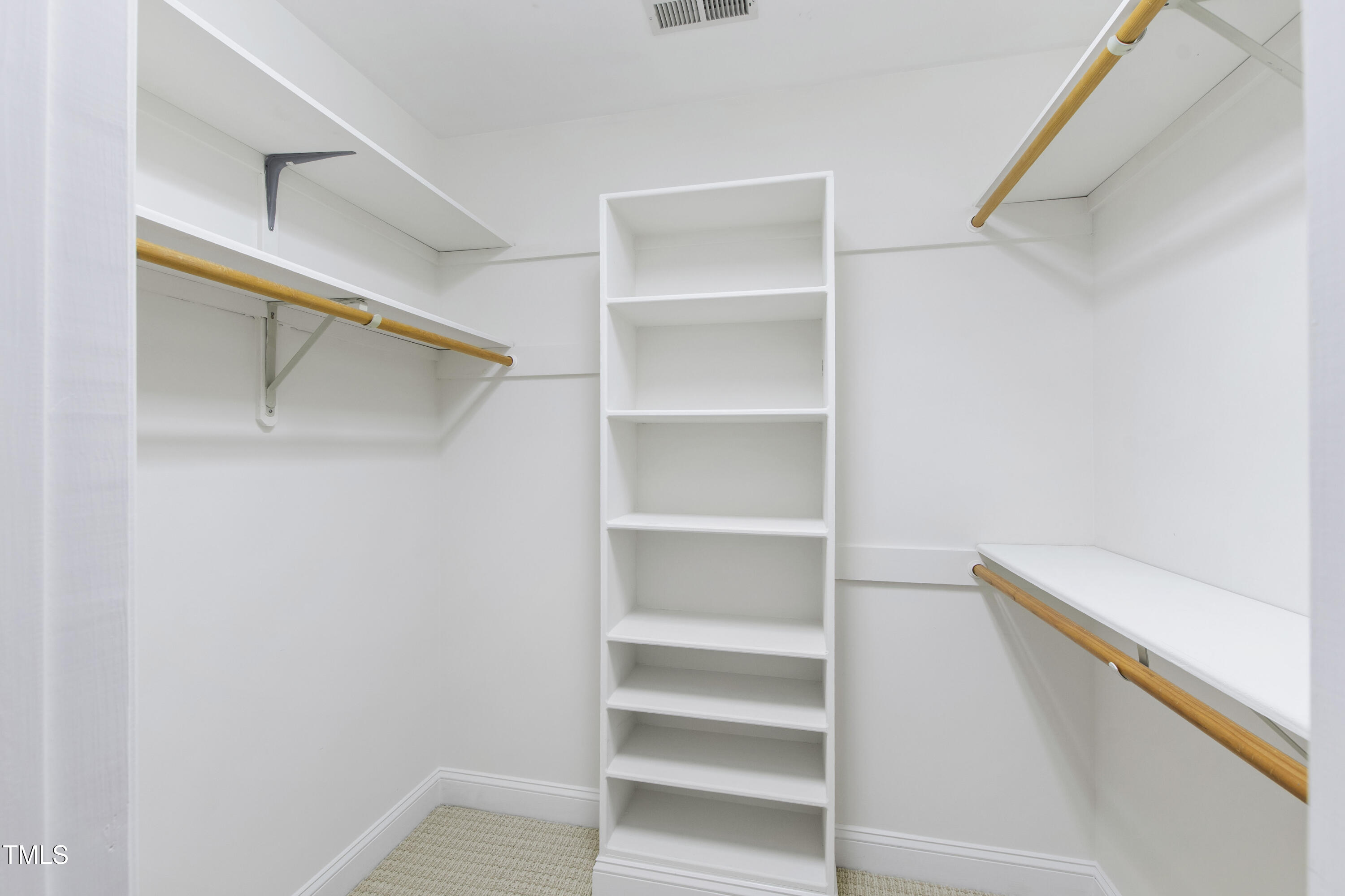2301 Upper Oaks Way Raleigh, NC 27615 - Photo 34 of 55 a view of walk in closet with empty racks