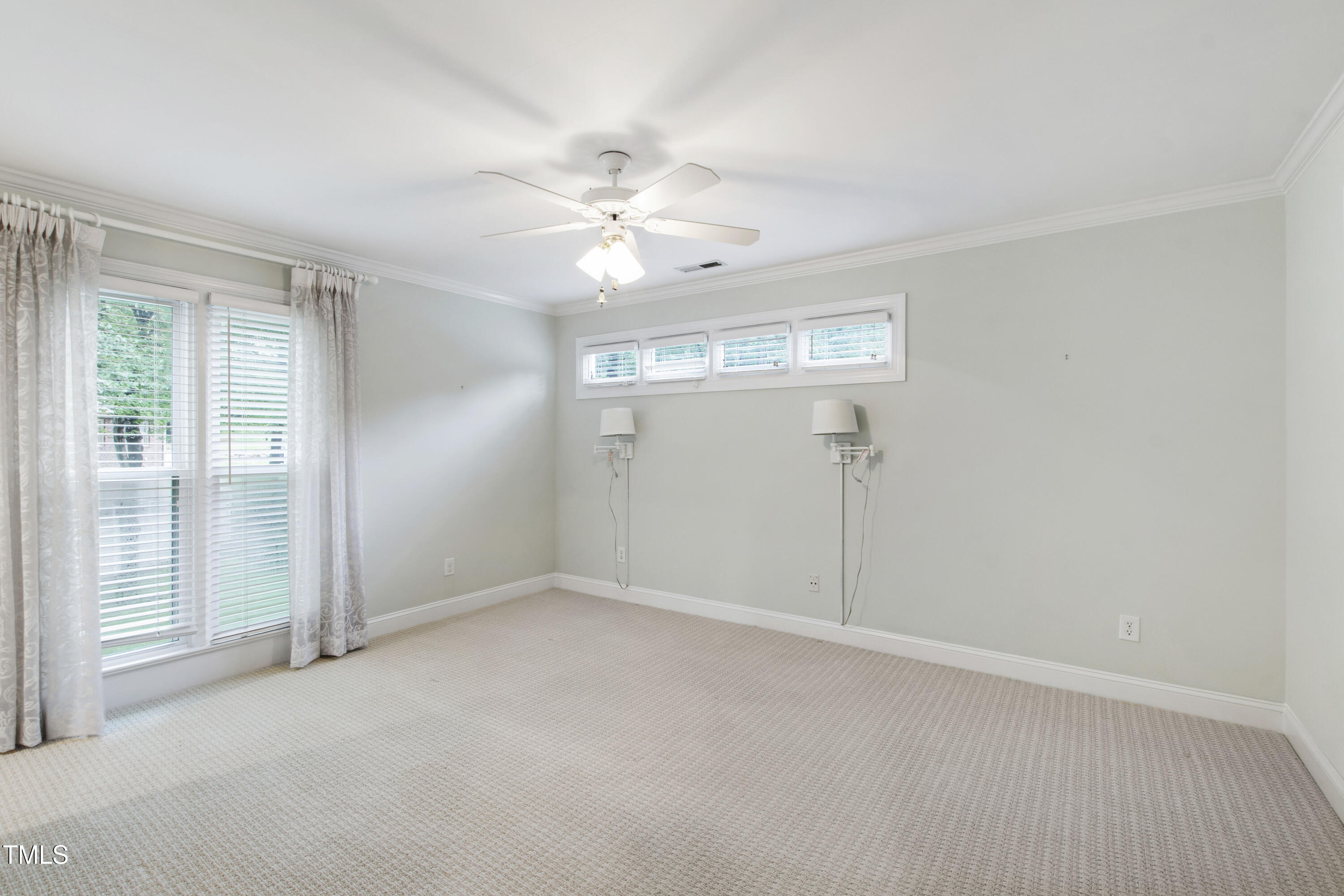 2301 Upper Oaks Way Raleigh, NC 27615 - Photo 36 of 55 an empty room with windows and fan