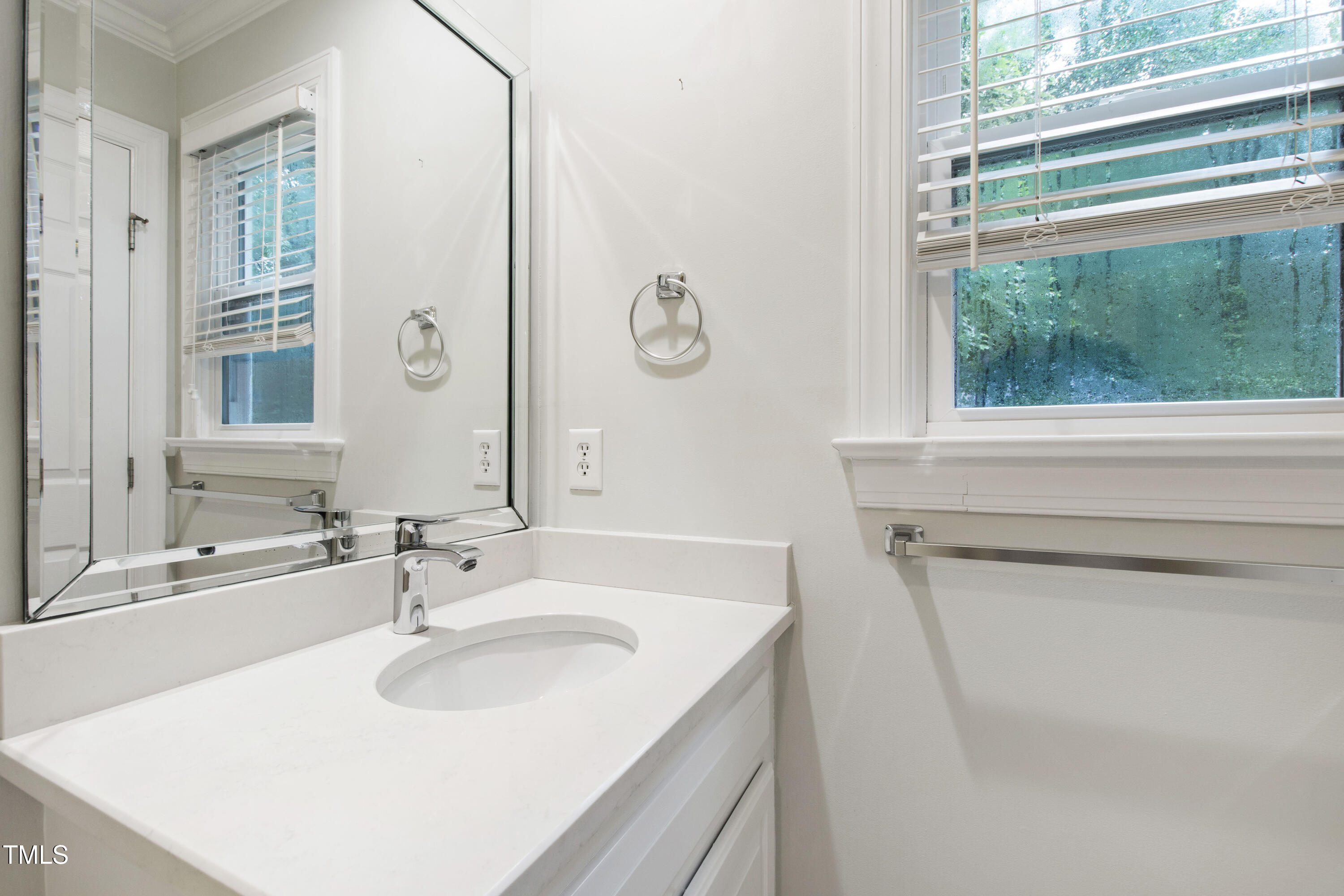 2301 Upper Oaks Way Raleigh, NC 27615 - Photo 37 of 55 a bathroom with a sink and a mirror