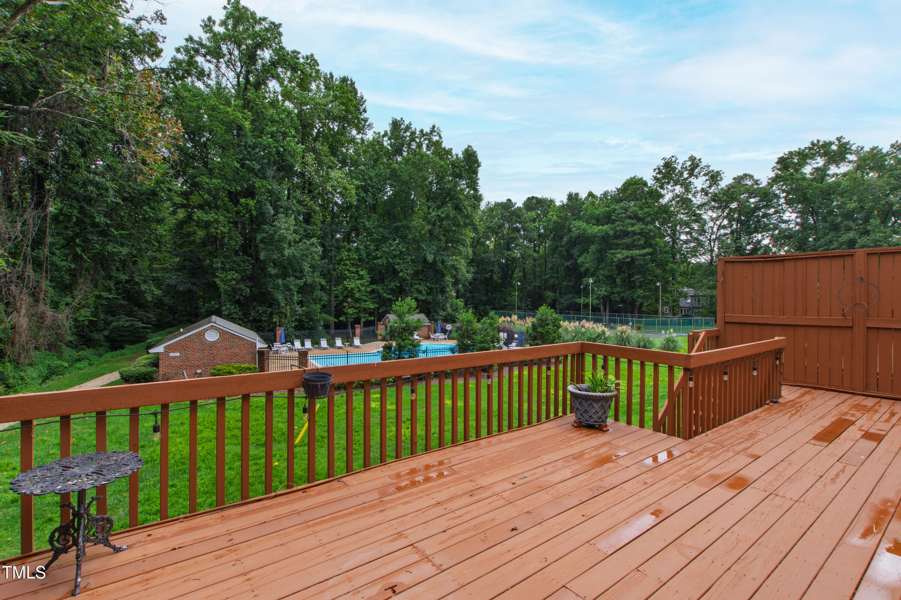 2301 Upper Oaks Way Raleigh, NC 27615 - Photo 47 of 55 a view of a wooden deck and a yard with lake view