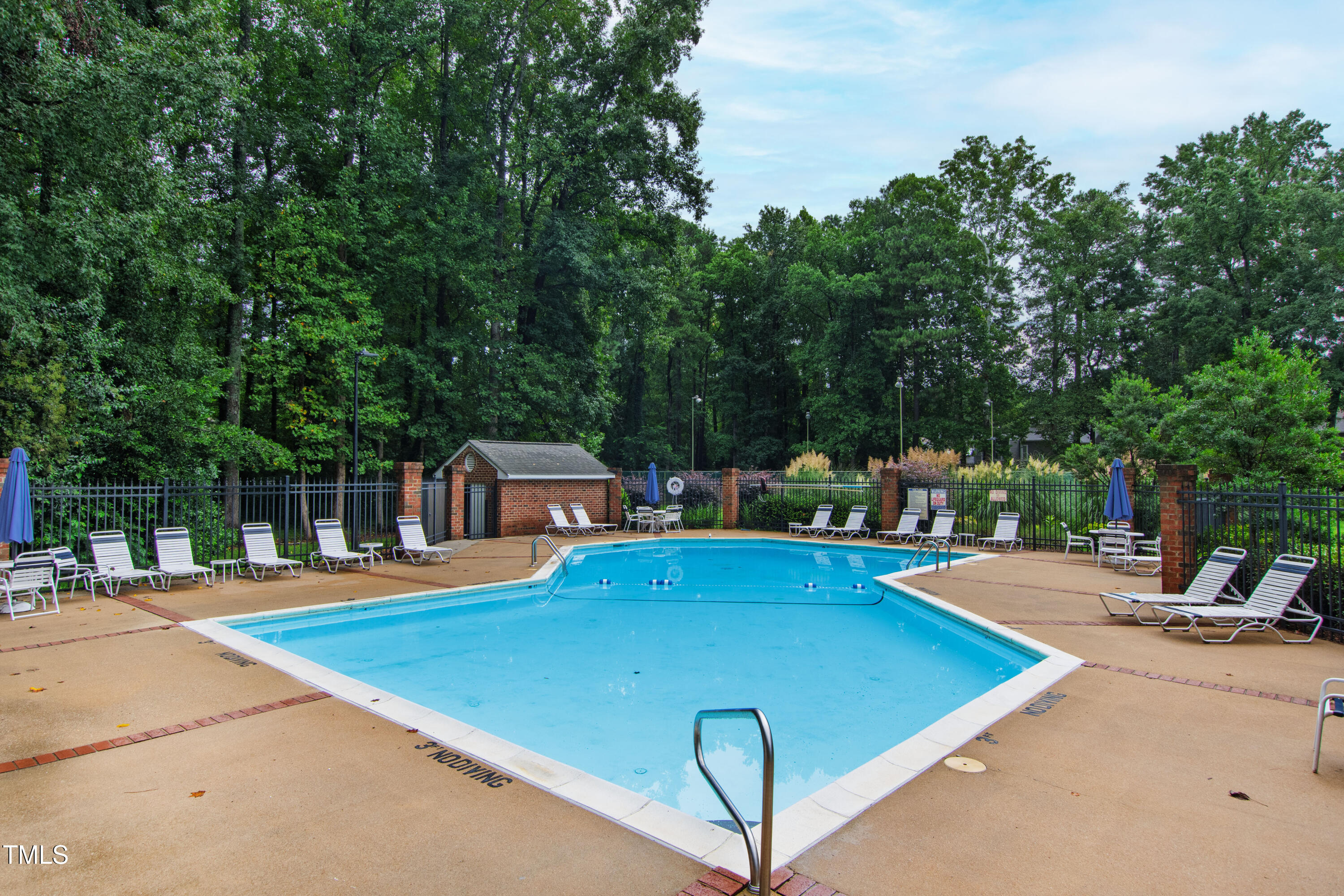 2301 Upper Oaks Way Raleigh, NC 27615 - Photo 52 of 55 a view of a swimming pool with lawn chairs and plants