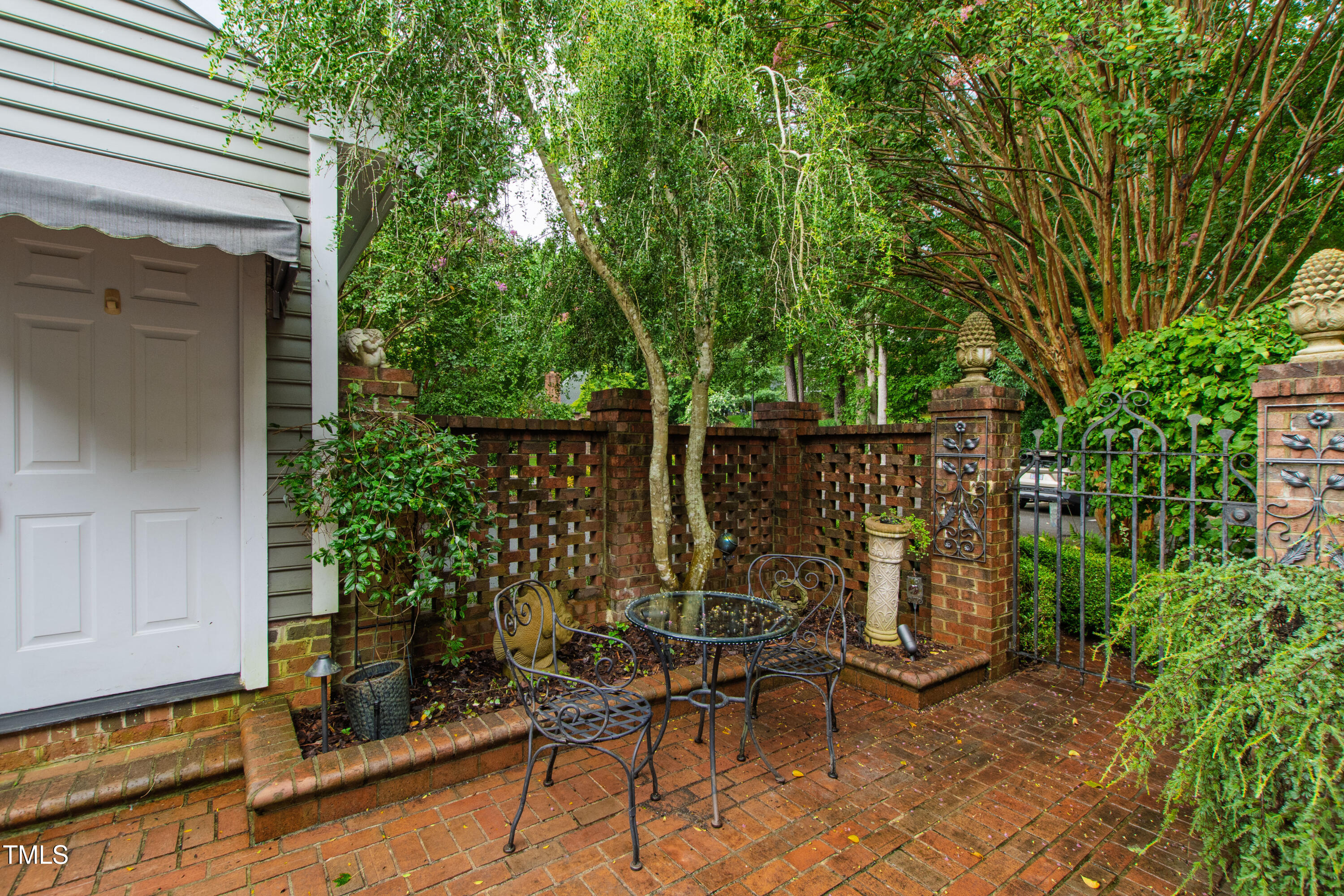 2301 Upper Oaks Way Raleigh, NC 27615 - Photo 6 of 55 a view of backyard with a table and chairs and potted plants