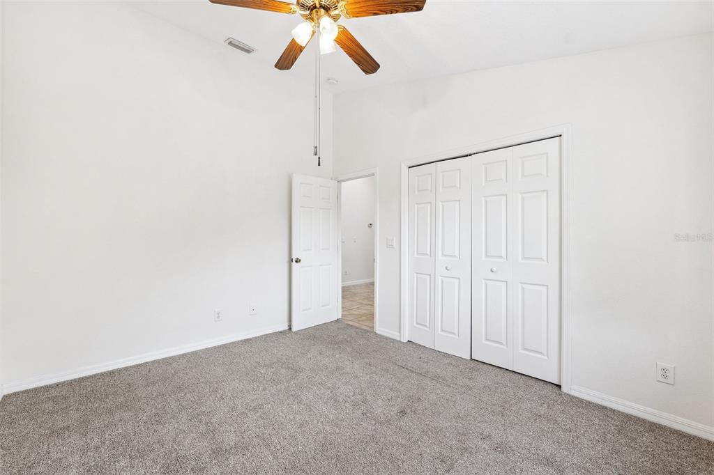 3209 Meta Court Largo, FL 33771 - Photo 11 of 24 an empty room with a chandelier fan